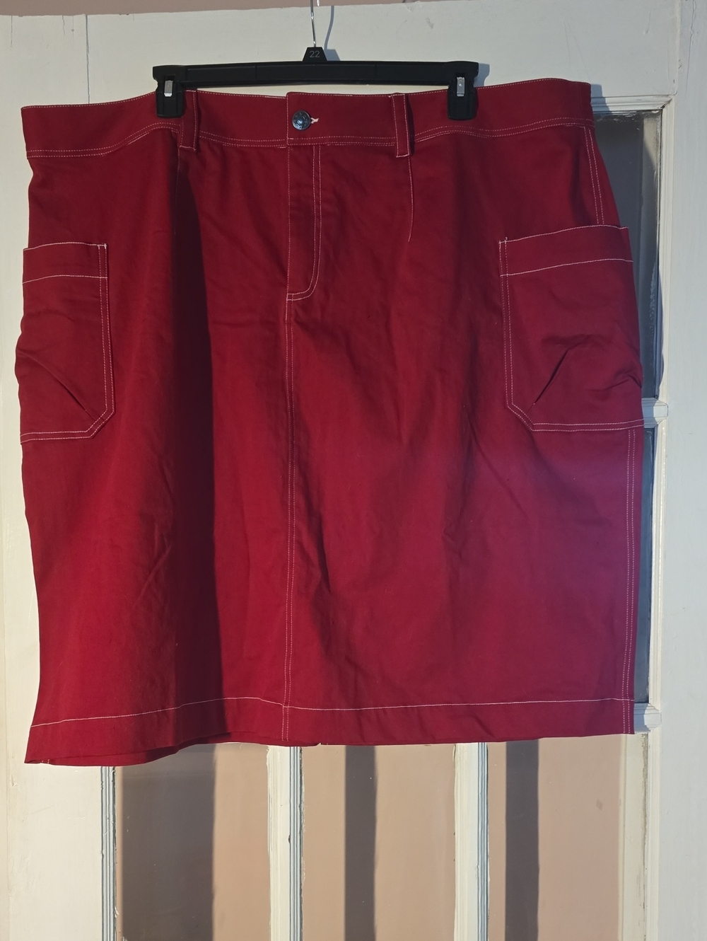 Adorable plus-sized red utility mini skirt with front pockets and belt loops
